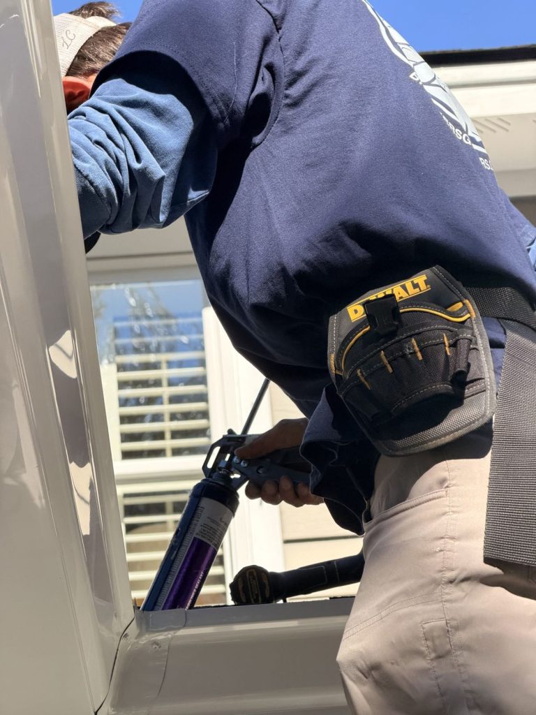 Installer's tool belt up close on the ladder