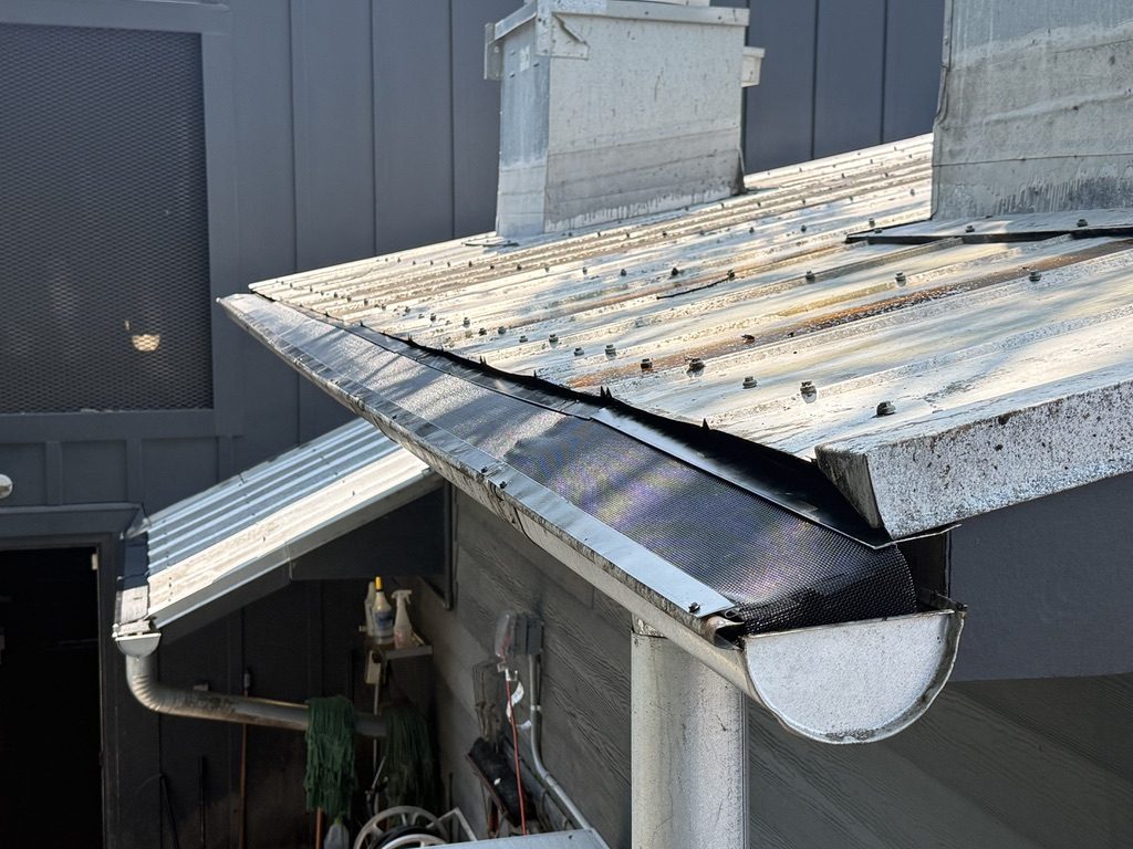 Half-round gutter under a standing seam metal roof